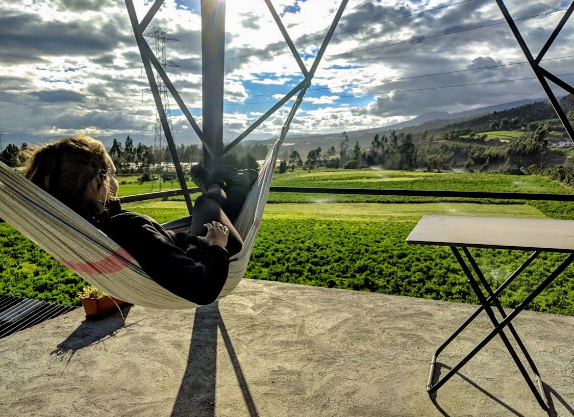 Guest relaxing in a hammock overlooking the countryside